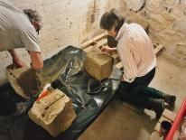 Conservator Sue Kelland and Heritage Centre Volunteer Dave Birch cleaning the stone.